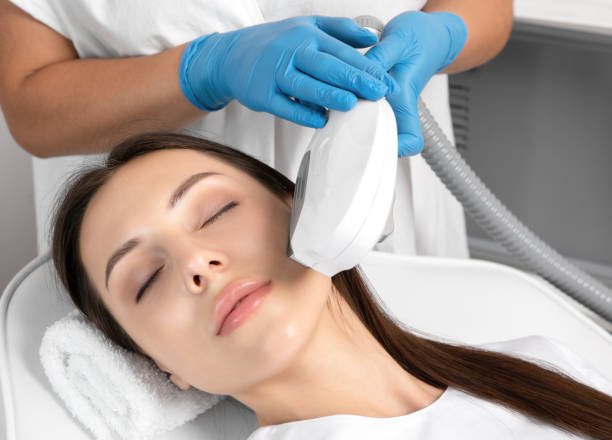 Elos epilation hair removal procedure on the face of a woman. Beautician doing laser rejuvenation in a beauty salon. Facial skin care. Hardware  ipl cosmetology