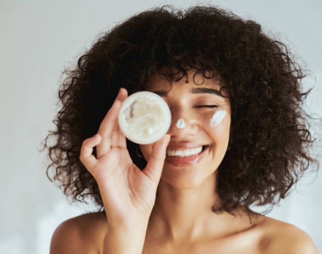 Cream, lotion and face of black woman with beauty product, skincare cosmetics and advertising isolated on white wall. Beautiful skin care person with container, moisturizer and essential oil mockup